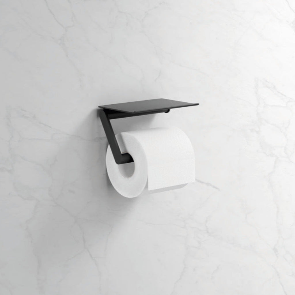 Black toilet paper holder with a roll of toilet paper on a white tiled wall.