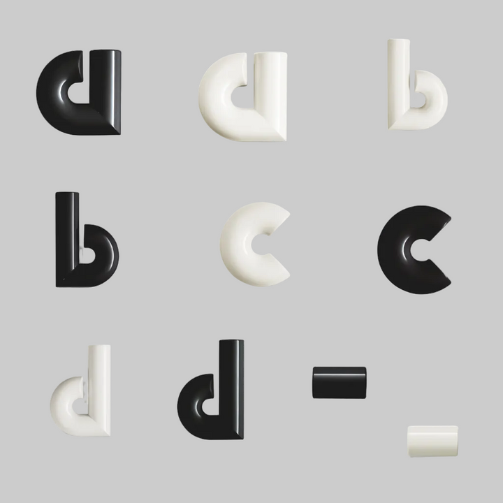 Black and white geometric letter-shaped objects on a white background