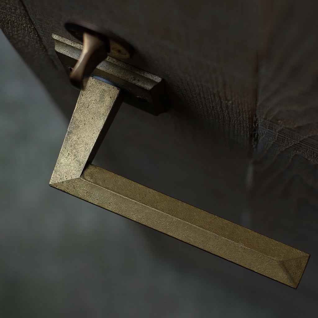A close up of a MATUREWARE Hex Lever handle on a door.