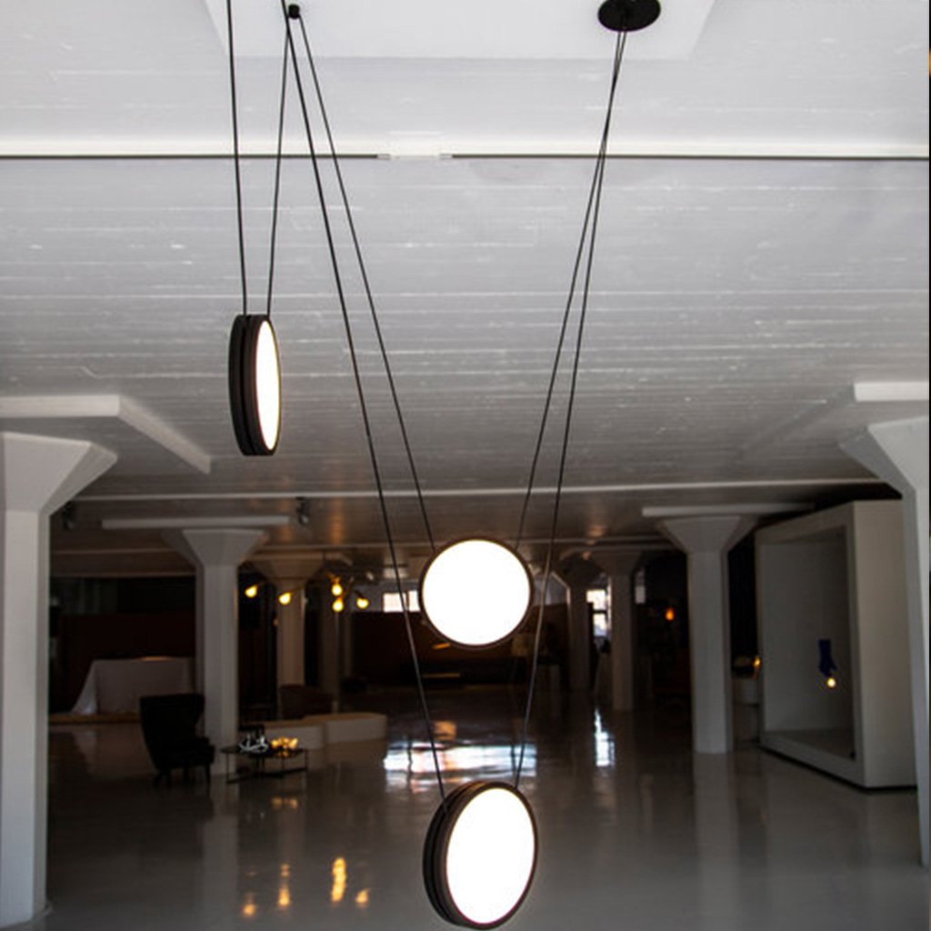 Matte black pendant lights balanced on individual wires