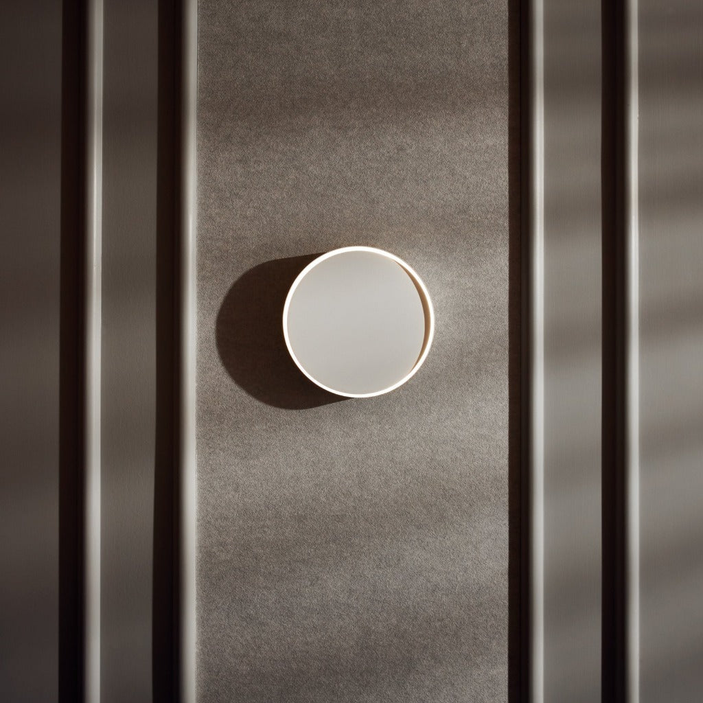 Horizon Wall Light appears to float softly off the wall, and with a simple push, you can change the direction and shadowing of the light source.