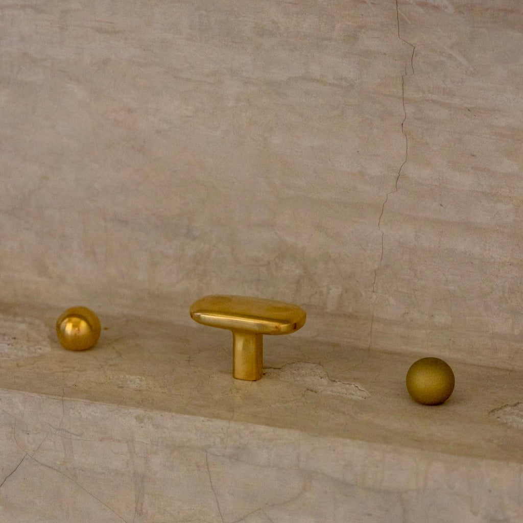 Smooth Polished Brass Cercle Knob next to Smooth Polished Brass Oval Knob/Hook and Sandblasted Bronze Cercle Knob