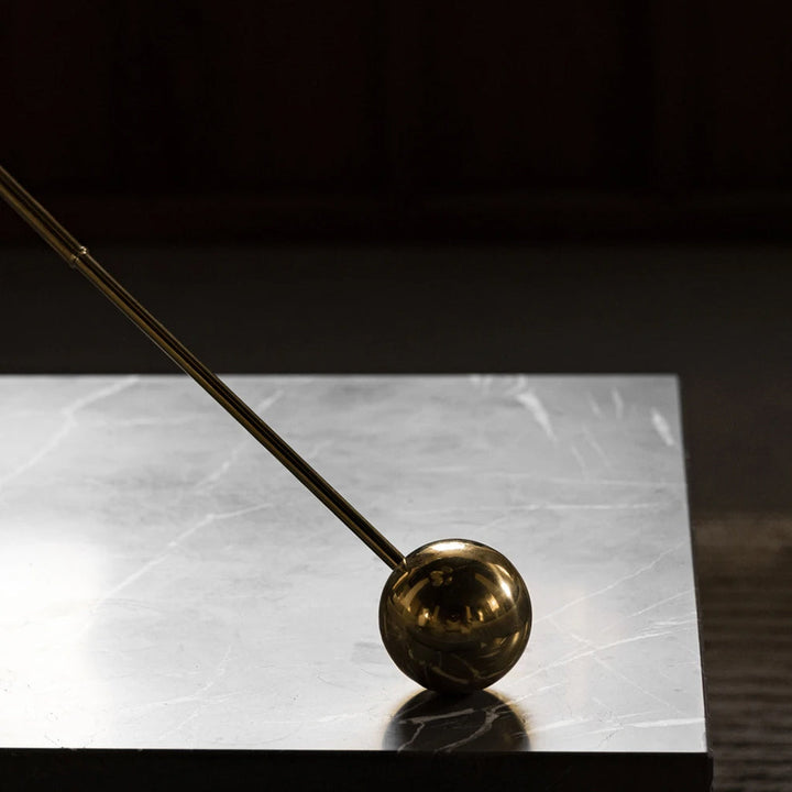 Detail of the bottom counter weight of the Interconnect Candle Holder in Brass.