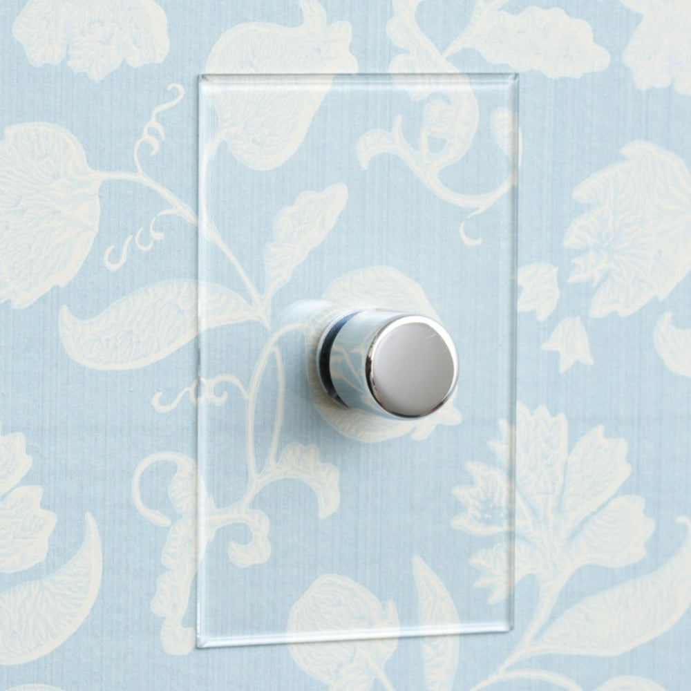 Forbes & Lomax invisible plate with a rotary dimmer on wallpaper.