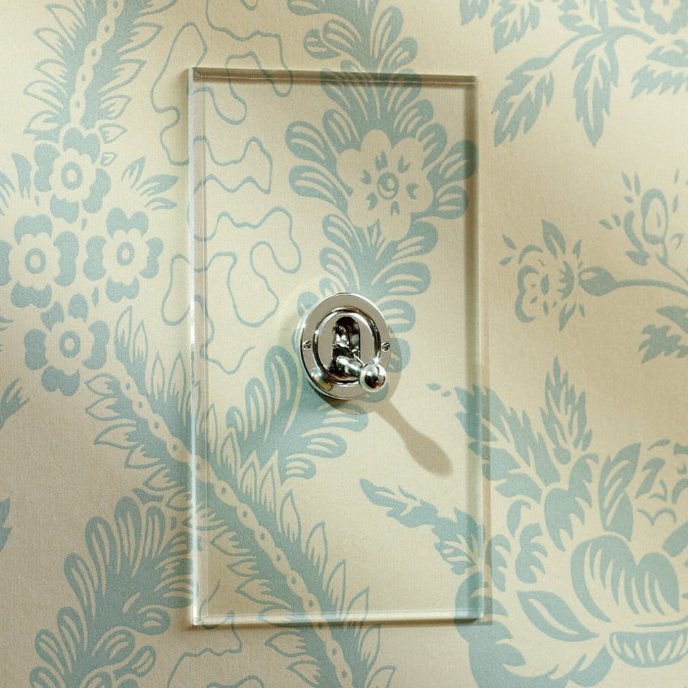 Forbes & Lomax invisible plate with a toggle switch on wallpaper.