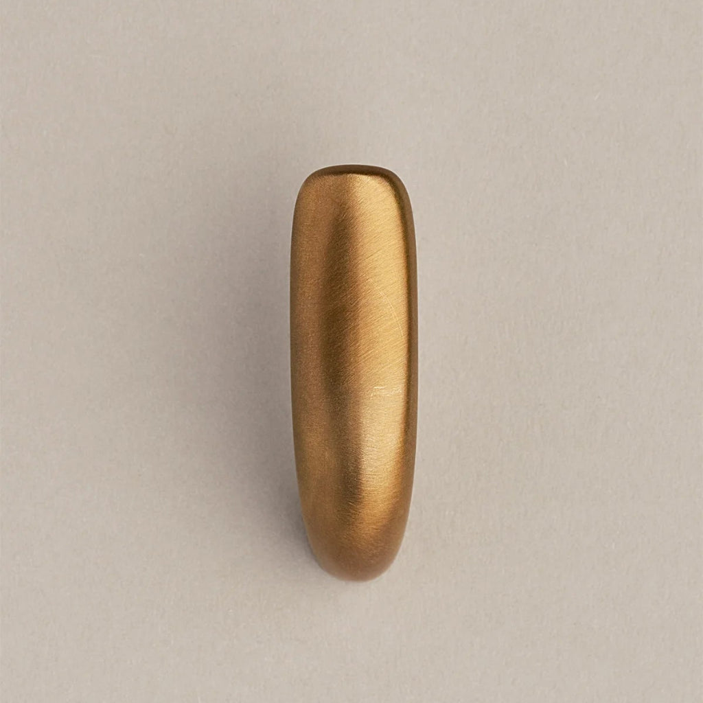 Softly curved J shaped hook in amber brass, front view.