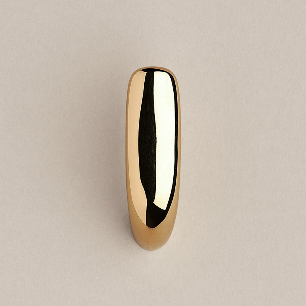 Softly curved J shaped hook in polished brass, front view.
