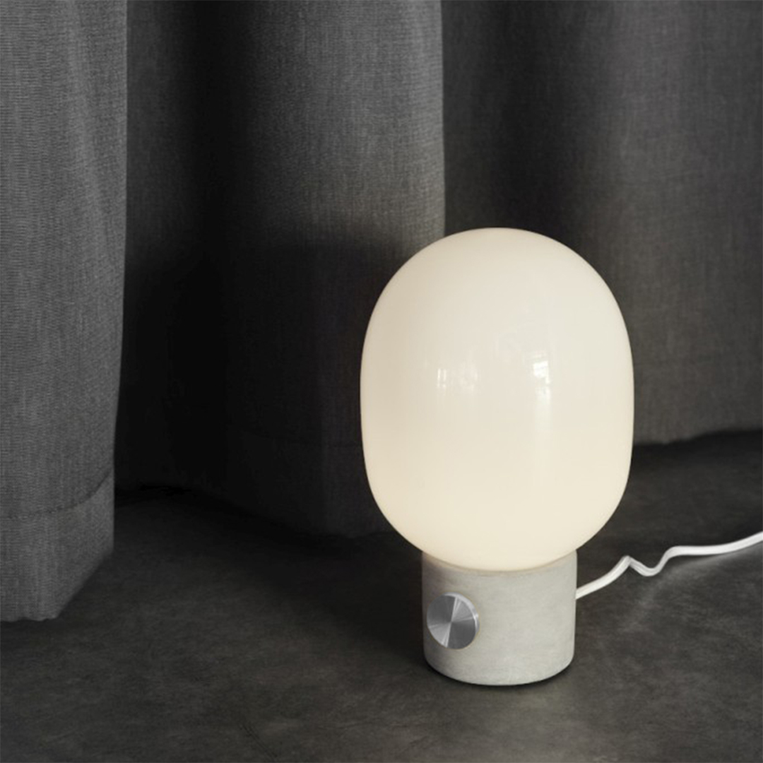 JWDA Concrete Table Lamp offers a simplified organic shape that beautifully blends contrasting elements. The raw and delicate meet harmoniously in this thoughtfully designed lamp, creating a unique and captivating form.