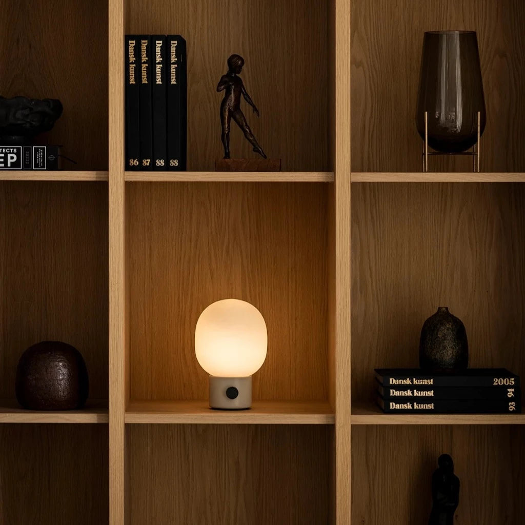 Table lamp on wooden bookshelf