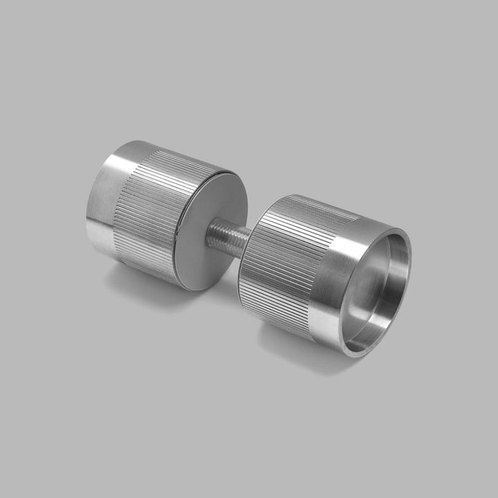 A pair of d line Knud Cylindrical Door Knobs on a gray background.