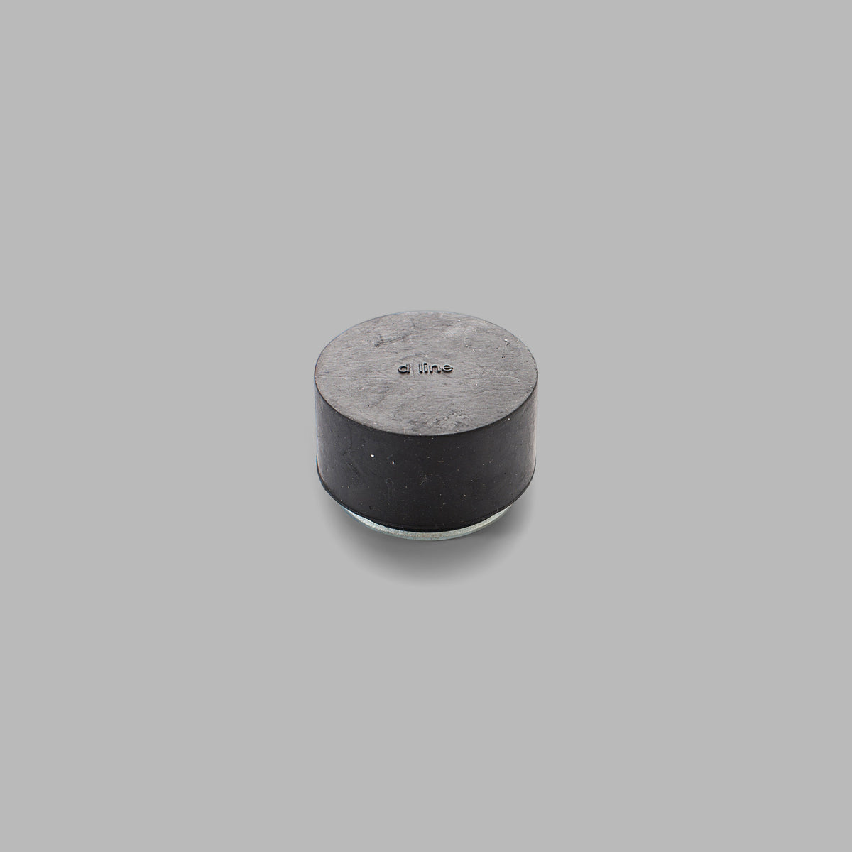 A d line Knud Floor Door Stop on a gray background.
