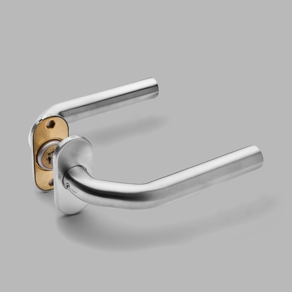 A close up of a d line Knud LF Lever door handle on a gray background.