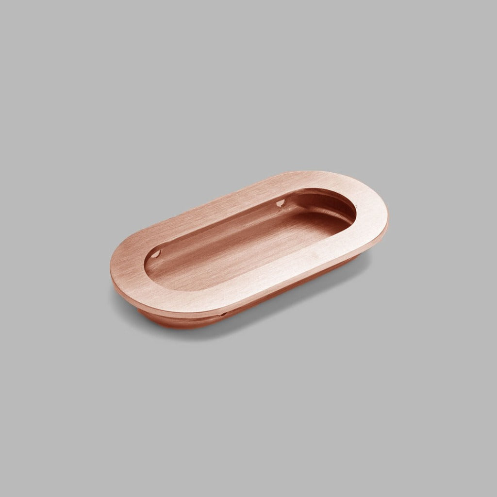 A dline knud oval flush pull in copper.