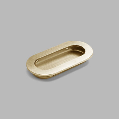 A dline Knud Oval flush pull in satin brass.