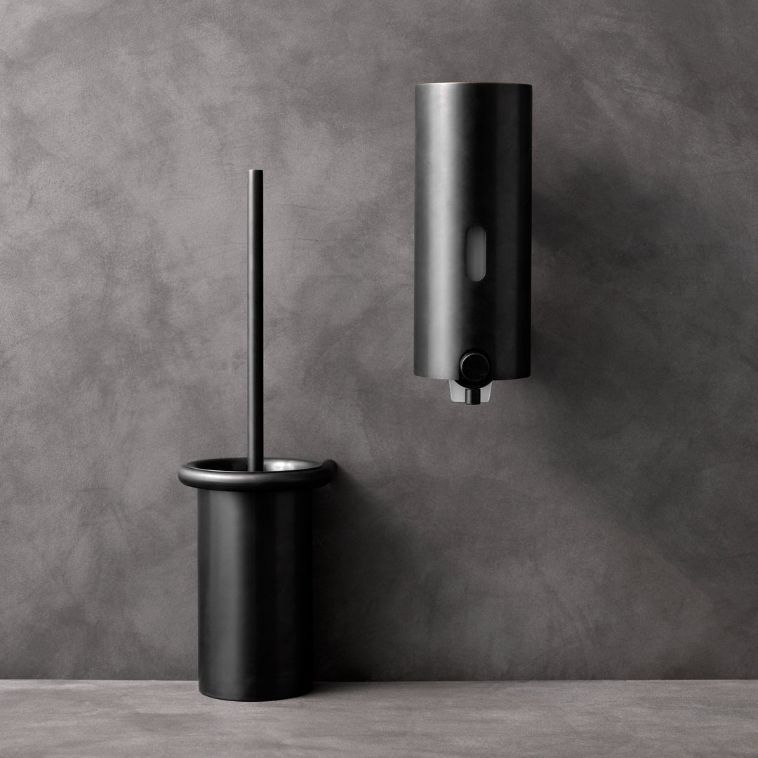 a Knud Soap Dispenser by d line and a toilet paper dispenser.