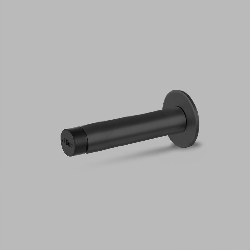 A d line Knud Wall Door Stop on a gray background.