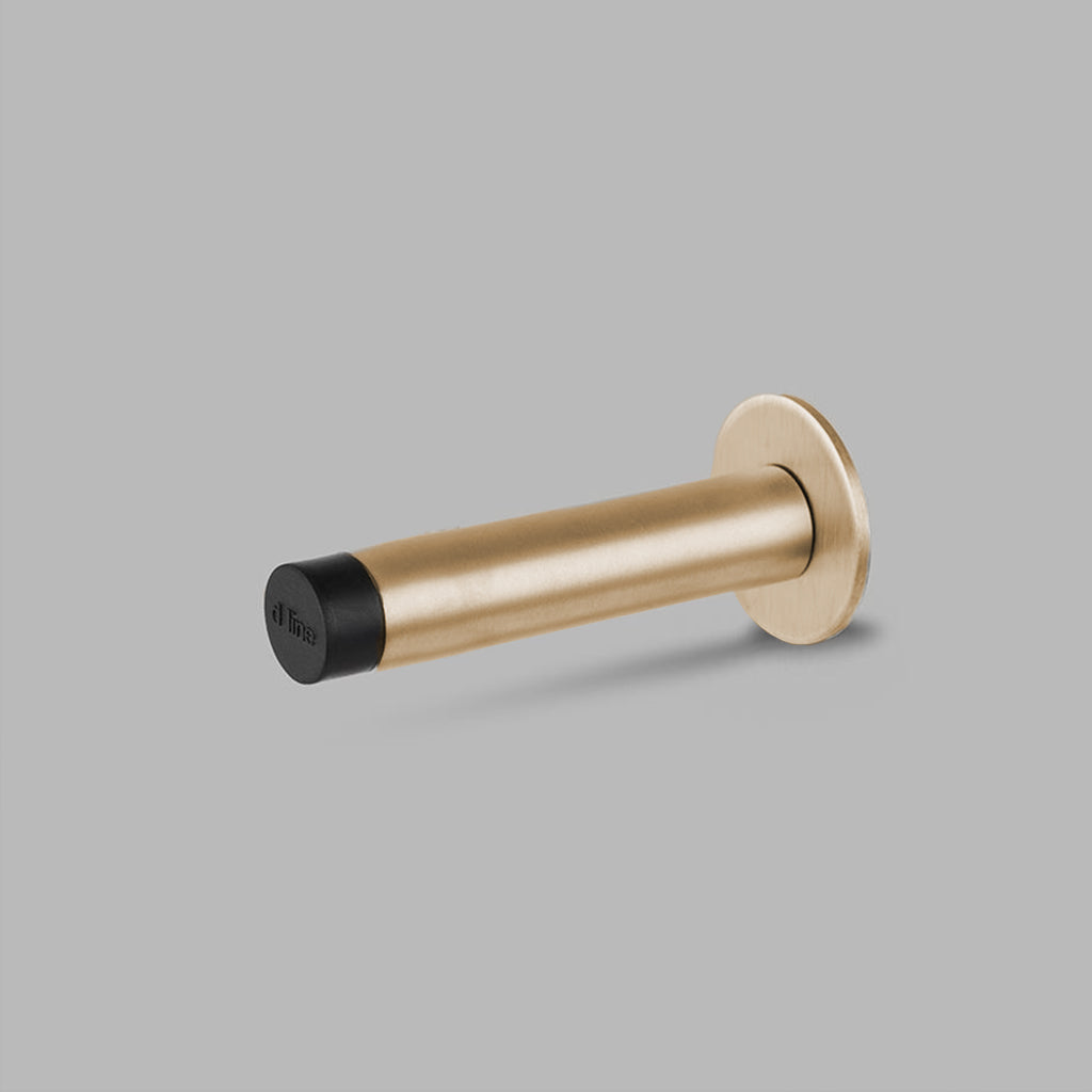a Knud Wall Door Stop from d line with a black handle.