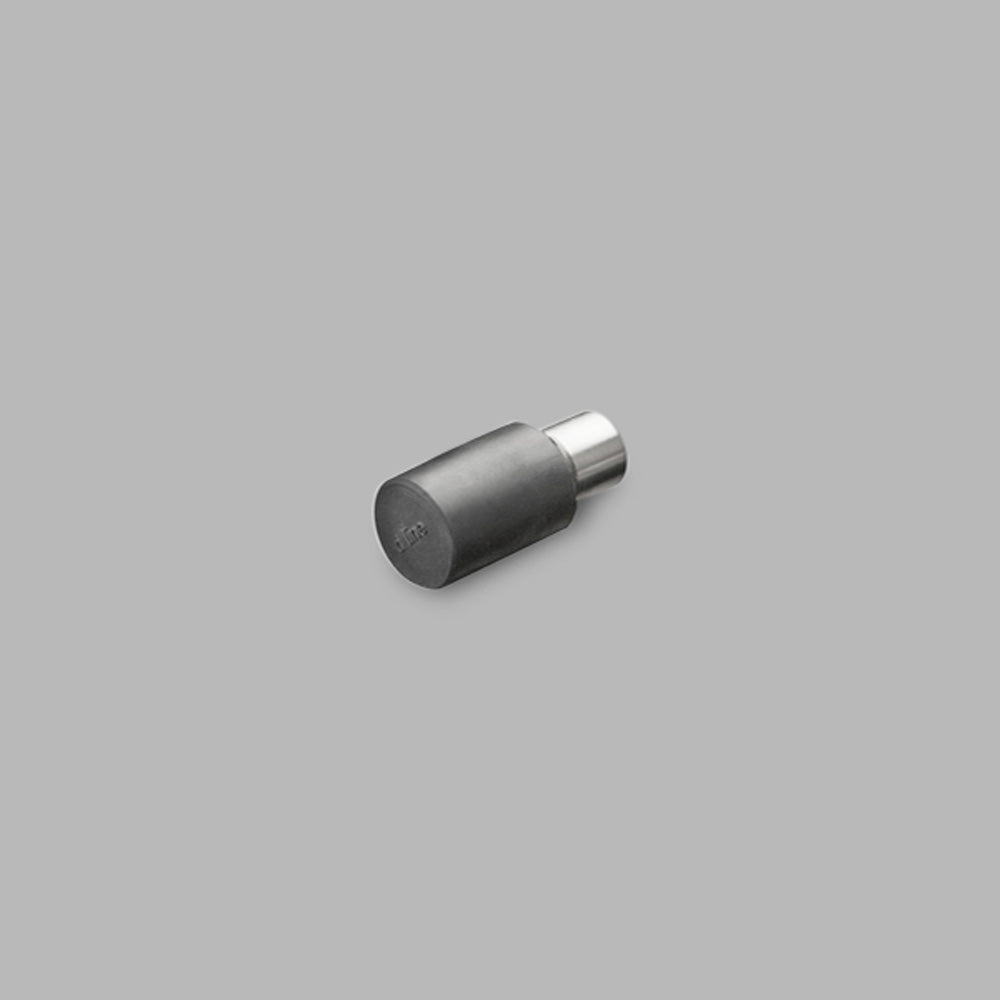 A d line Knud Wall Door Stop on a gray background.