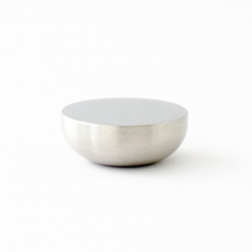 Round knob in brushed stainless steel by Baccman Berglund