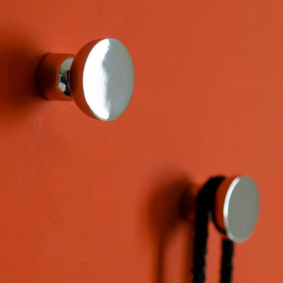 Round knob / hooks in polished stainless steel mounted on wall