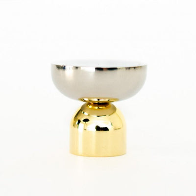 A Kokeshi Mix Knob/Hook by Baccman Berglund sitting on top of a white table.
