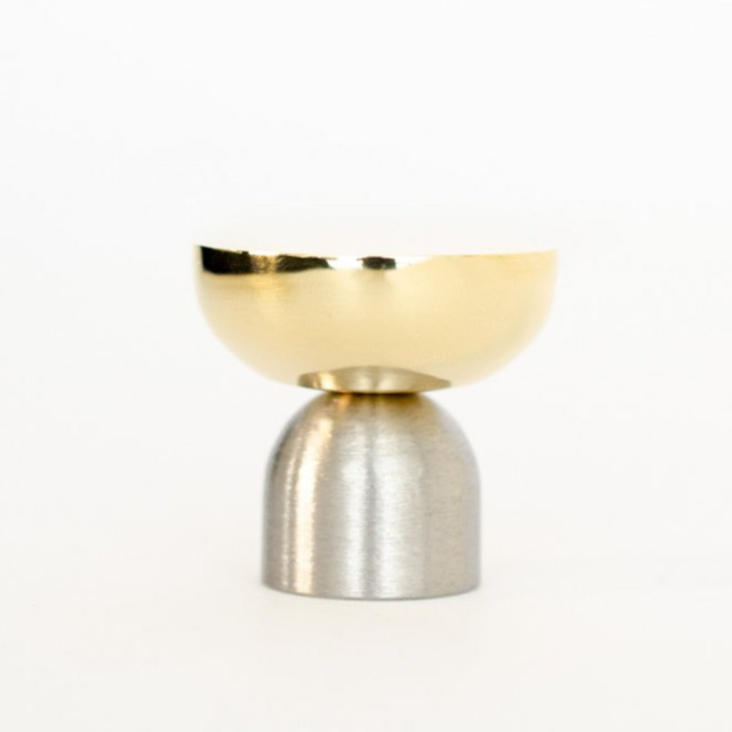 A Kokeshi Mix Knob / Hook by Baccman Berglund sitting on top of a metal stand.