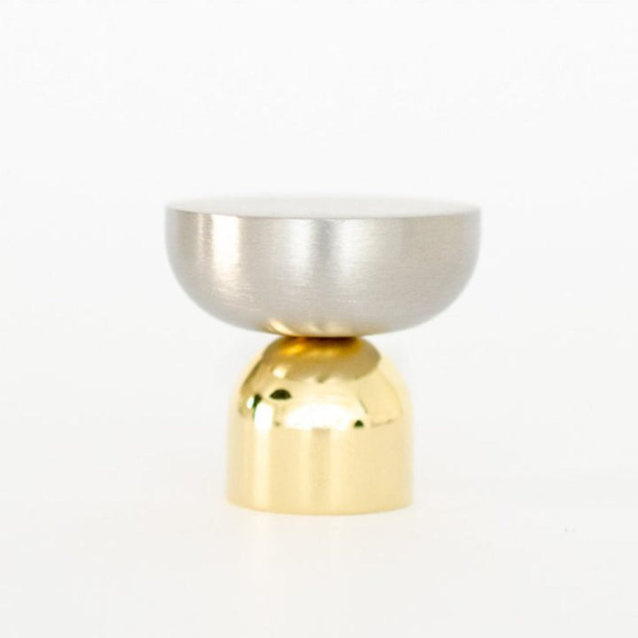 A Kokeshi Mix Knob / Hook by Baccman Berglund sitting on top of a white table.