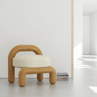 Lithic lounge chair in natural oak with beige upholstery in white room