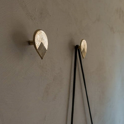 A couple of Mi & Gei Libre Forme No. 6 hooks on a wall next to a wall.