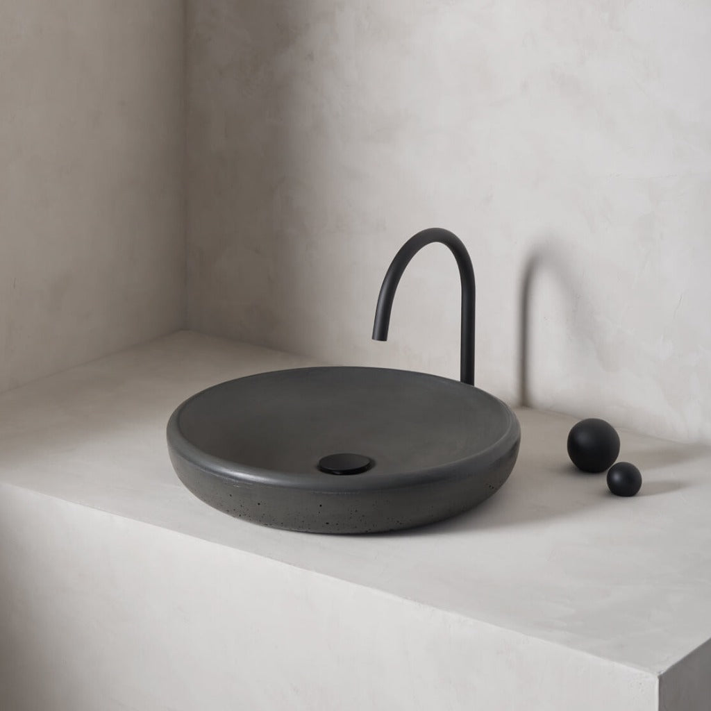 A large, circular washbowl with a gradual shallow slope and low-profile, round-over basin walls