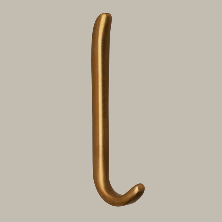 Long J shaped hook in amber brass, side view.