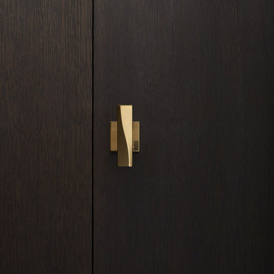 Elegant brass door knob with square rose on a dark wood door. Beautifully and functionally designed.