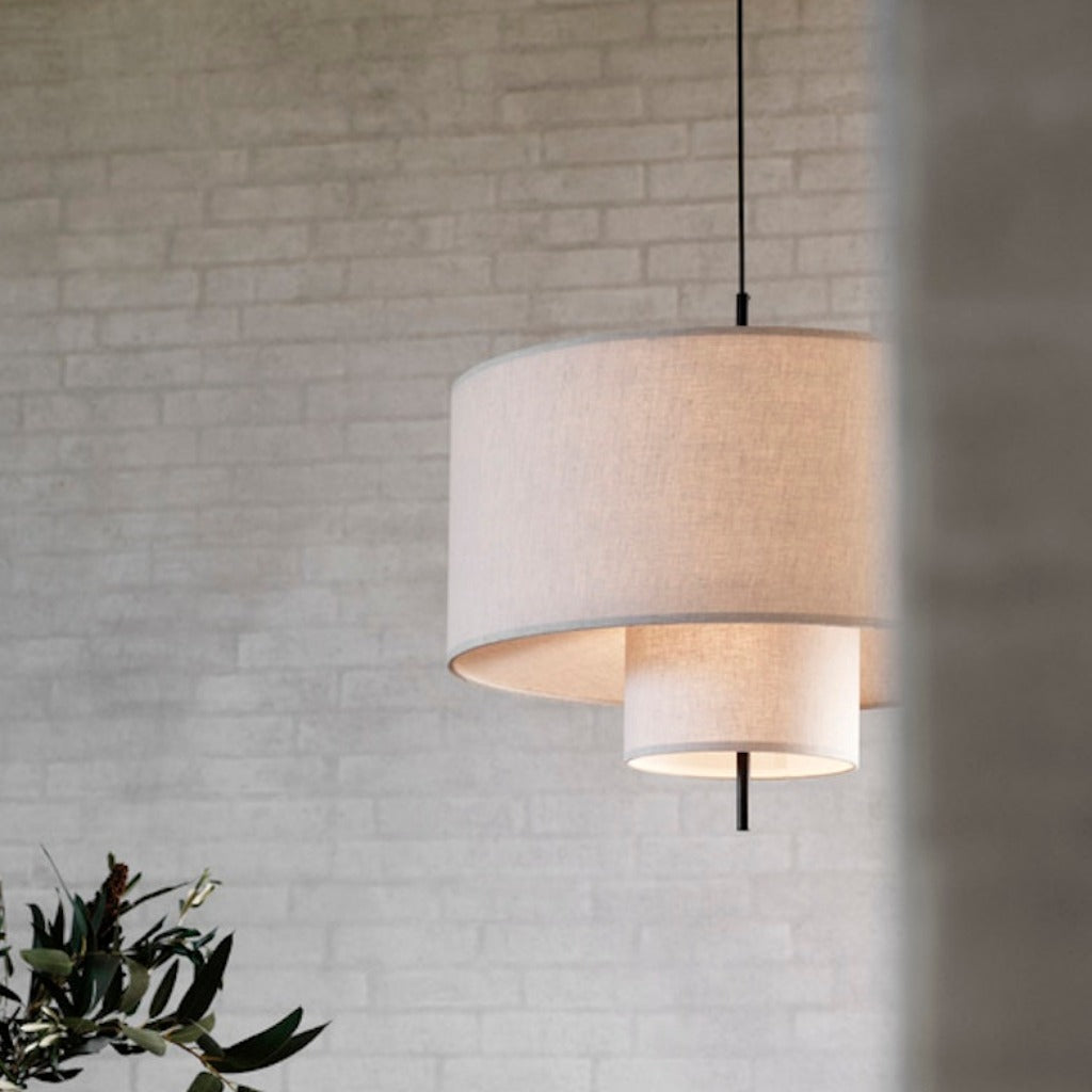 A round, tiered pendant lamp hung from ceiling