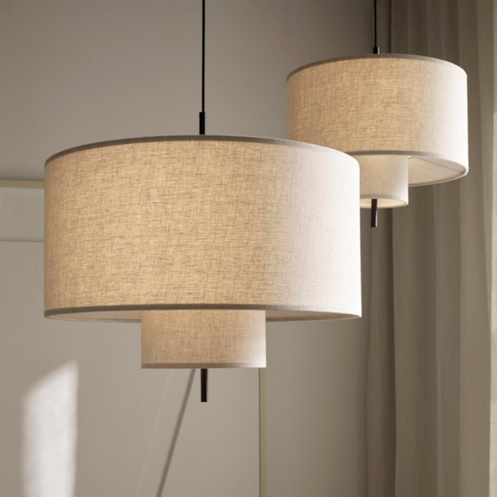 Two round, tiered pendant lamps hung from ceiling