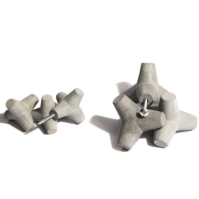 A pair of Urbi et Orbi Marine Knobs/Hooks with screws on them.