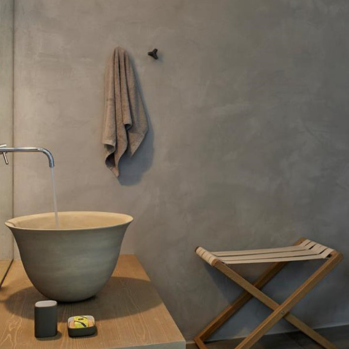 A bathroom with a Urbi et Orbi Marine Knob sink and Urbi et Orbi towel rack.