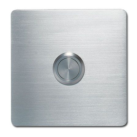A brushed metal surface with a Serafini Modern Square Doorbell.
