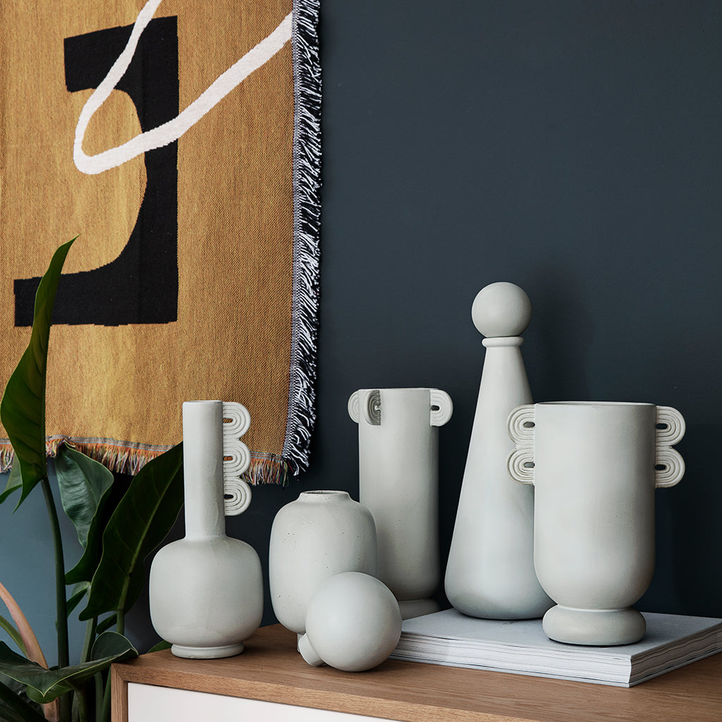 A group of Ferm Living Muses Vase Ania sitting on top of a wooden table.