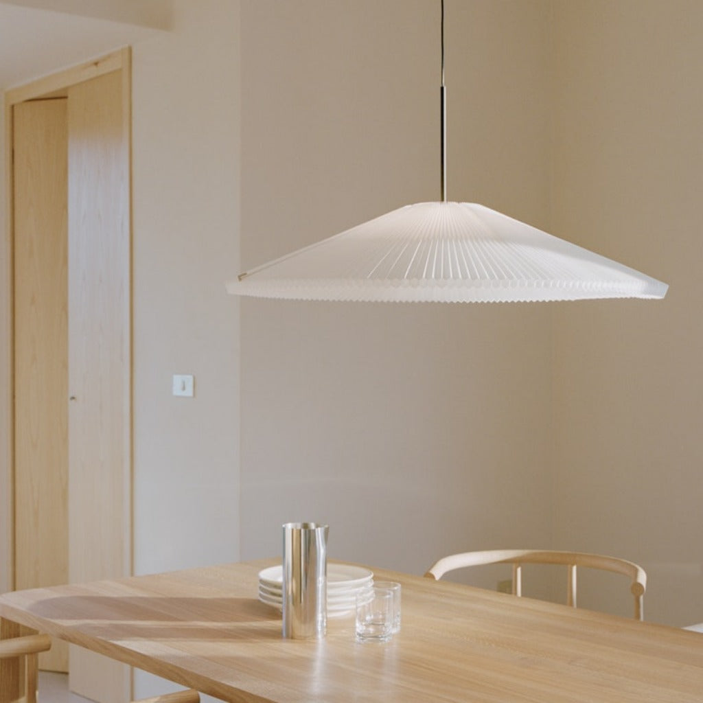 Large pendant lamp hung over wooden dining table