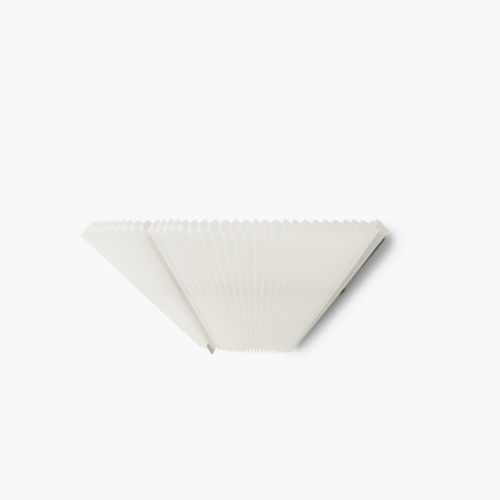 A white, pleated wall lamp