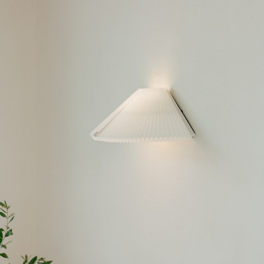 A white, pleated wall lamp