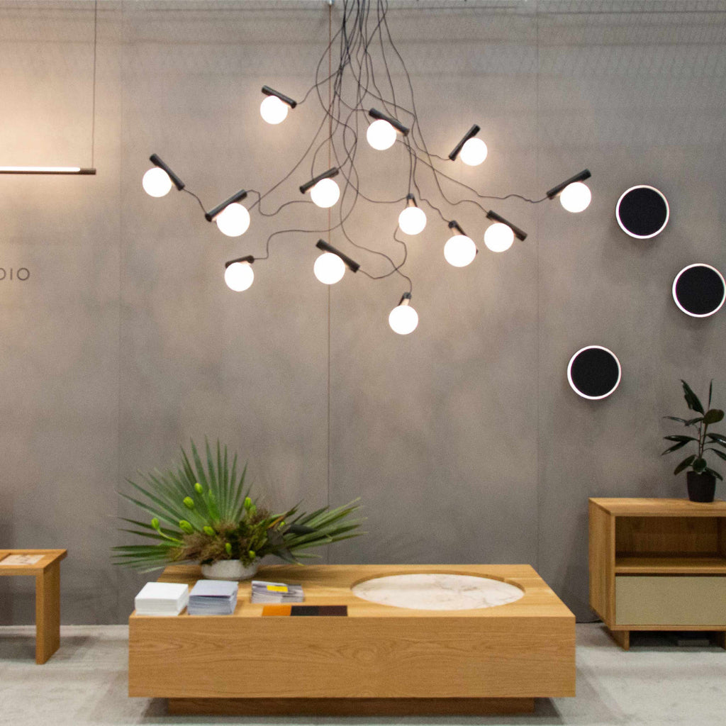 Modern interior design with a chandelier, wooden table, and decorative elements.