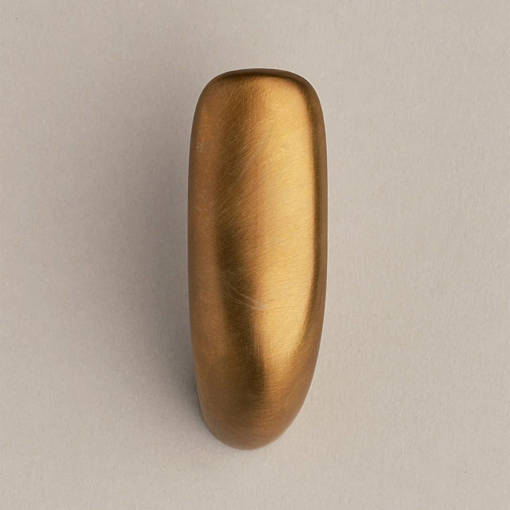 Softly curved J shaped hook in amber brass, front view.