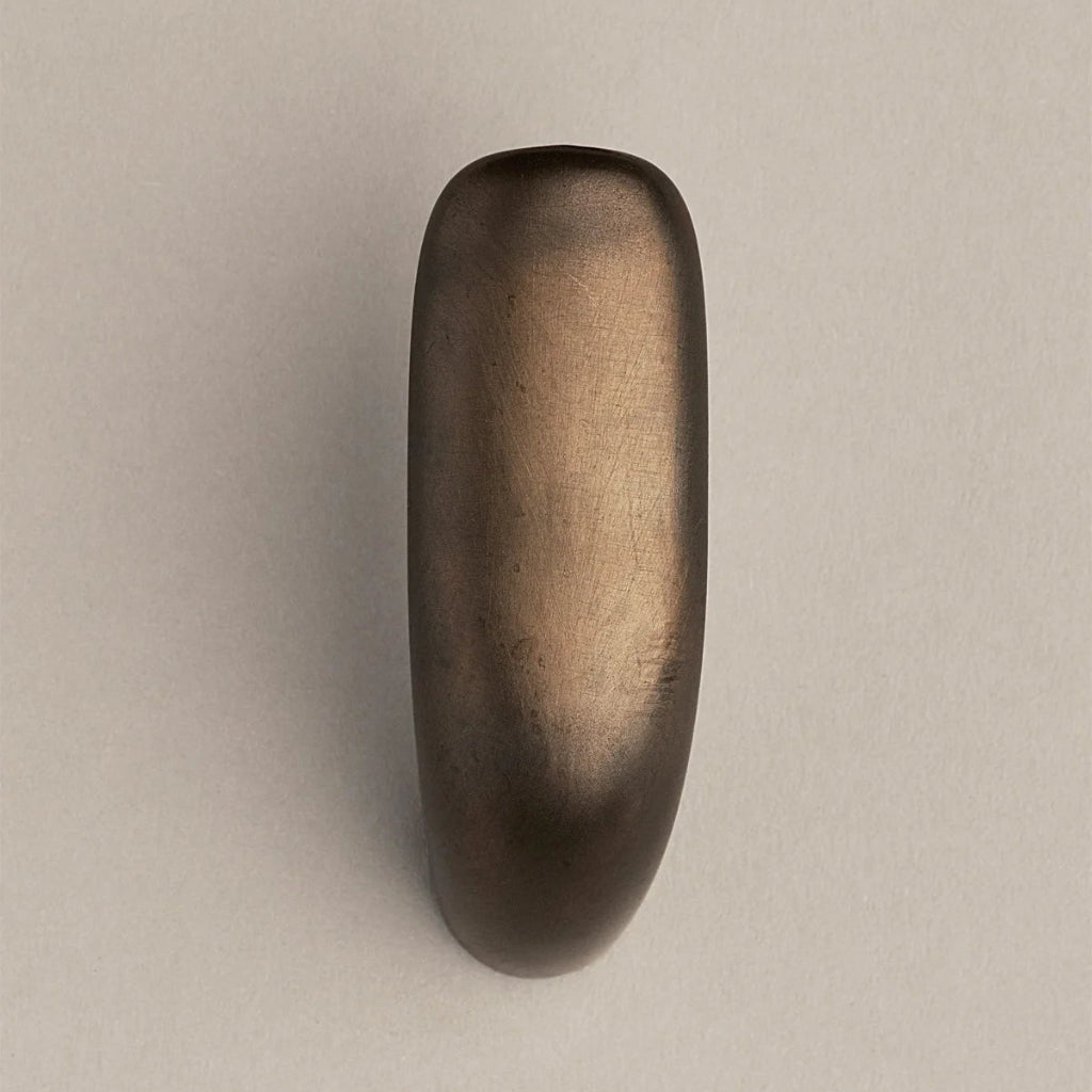 Softly curved J shaped hook in dark brass, front view.