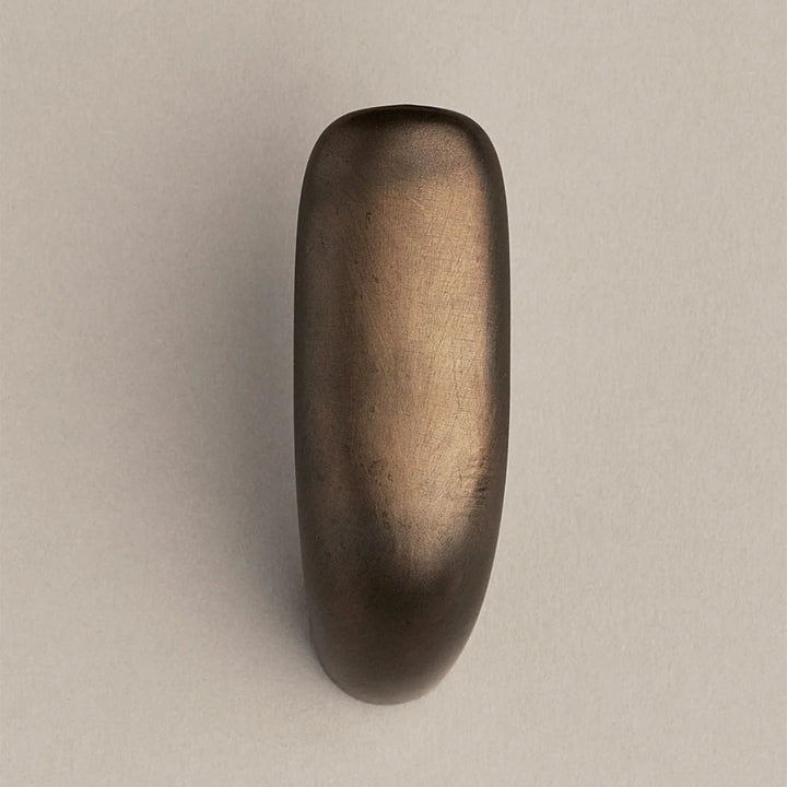 Softly curved J shaped hook in dark brass, front view.