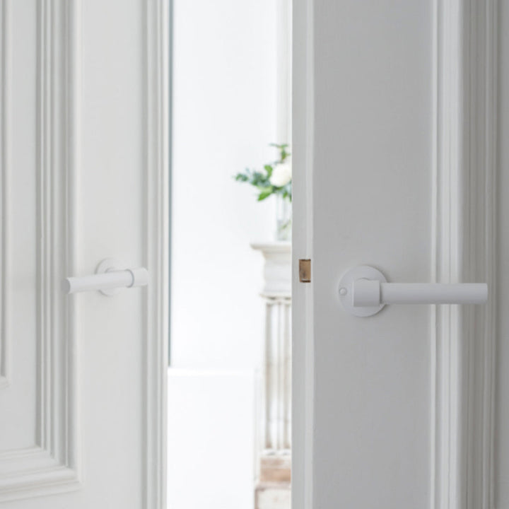 A white Formani door with a ONE by Piet Boon Door Lever handle on it.