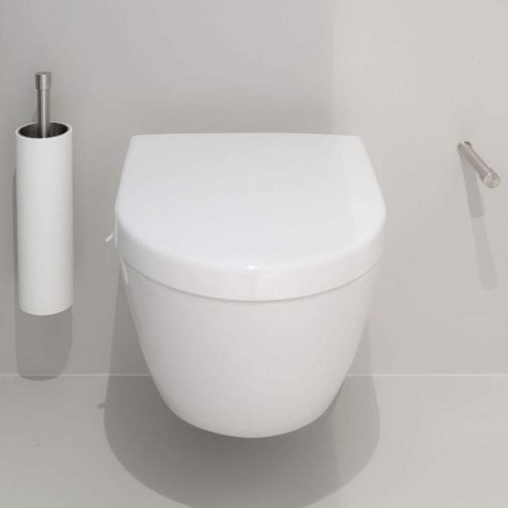 A white Formani toilet with the ONE by Piet Boon Spare Toilet Roll Holder sitting next to a roll of toilet paper.
