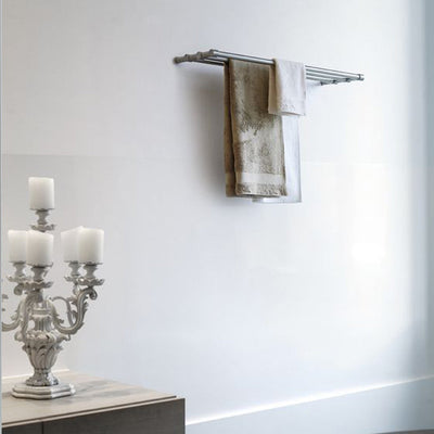 A ONE by Piet Boon Towel Bar Rack hanging on a towel rack next to a candelabra, made by Formani.