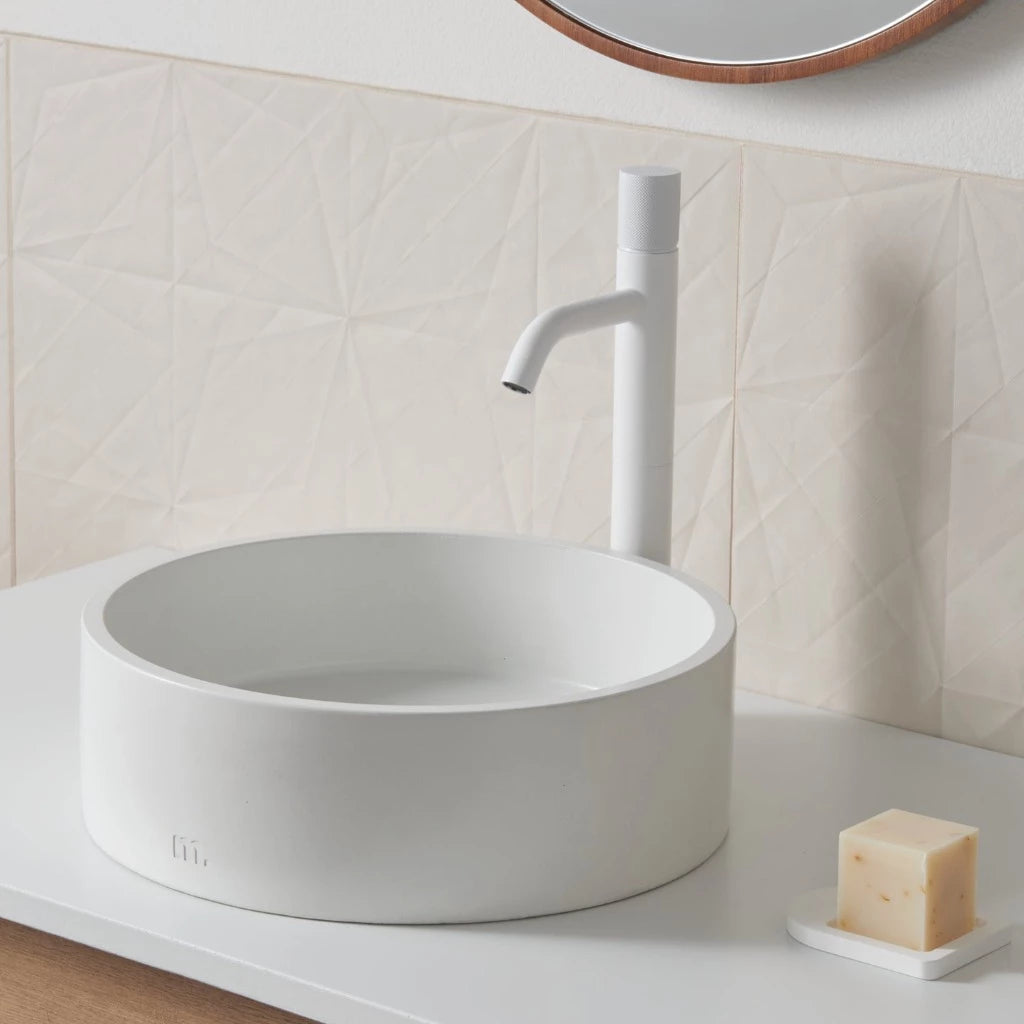 An Odet Basin SM by mudd. concrete sitting on top of a white counter.
