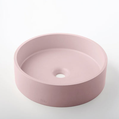 A mudd. concrete Odet Basin LG sink in pink on a white surface.